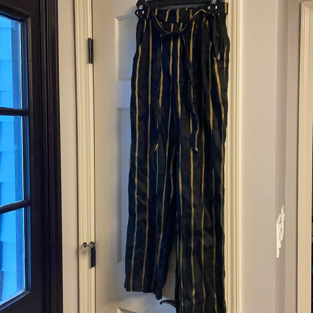First Monday black pants with gold stripes